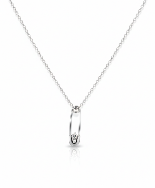 Elegant silver safety pin pendant with a sparkling stone