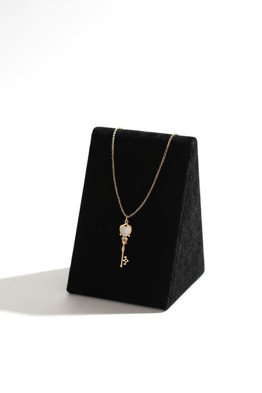 Charming rose gold key pendant with a heart design