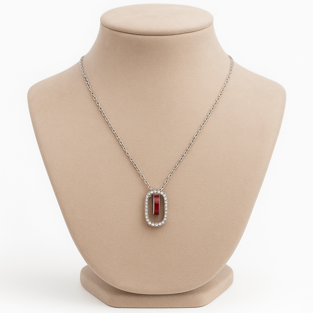 Elegant silver necklace featuring a deep red gemstone framed with sparkling stones
