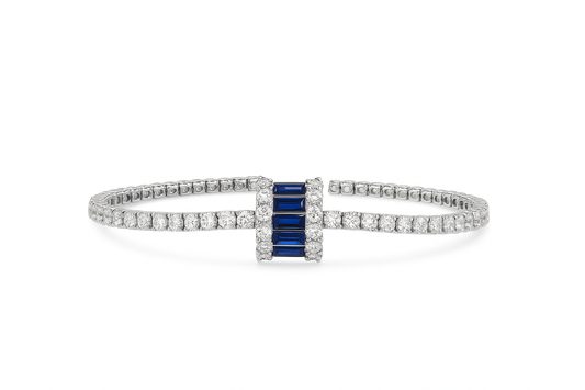 silver tennis bracelet with a bold blue crystal centerpiece
