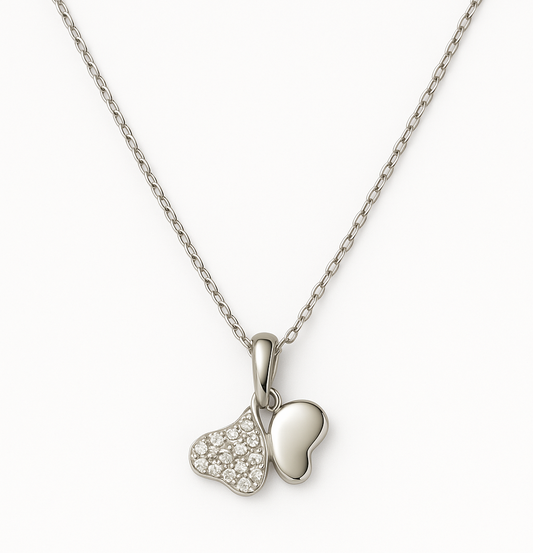 Elegant silver pendant featuring dual heart charms