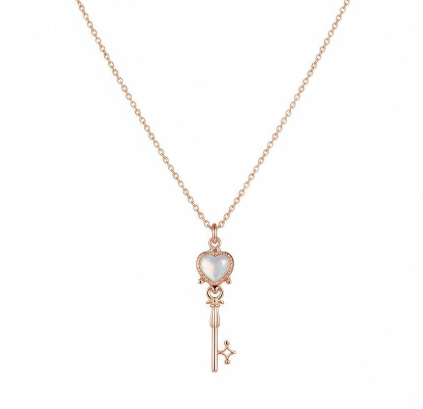 Charming rose gold key pendant with a heart design