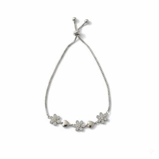 Silver bracelet featuring charming pave-set and crystal flowers with smooth silver hearts.
