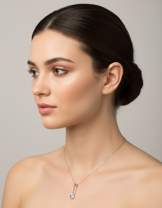 Elegant silver safety pin pendant with a sparkling stone