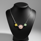 Delicate sterling silver necklace featuring three colorful floral charms