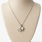 Elegant silver pendant featuring dual heart charms