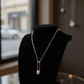Elegant silver safety pin pendant with a sparkling stone